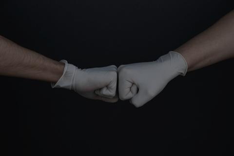 two people fist bumping
