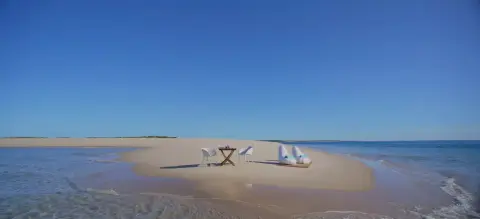 Azura Benguerra dining on the beach