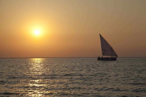 a dhow sailing in the sunset